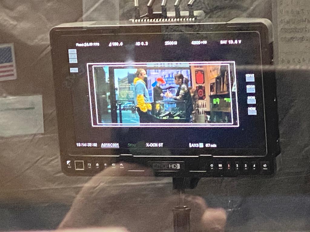 Behind-the-scenes camera monitor showing a scene being filmed inside Ideal Jewelry and Loan for the Paramount movie “Finest Kind”