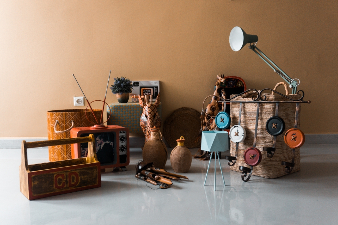 Assorted vintage and collectible items including a retro TV, lamps, baskets, and crafts on display, representing popular pawnable goods