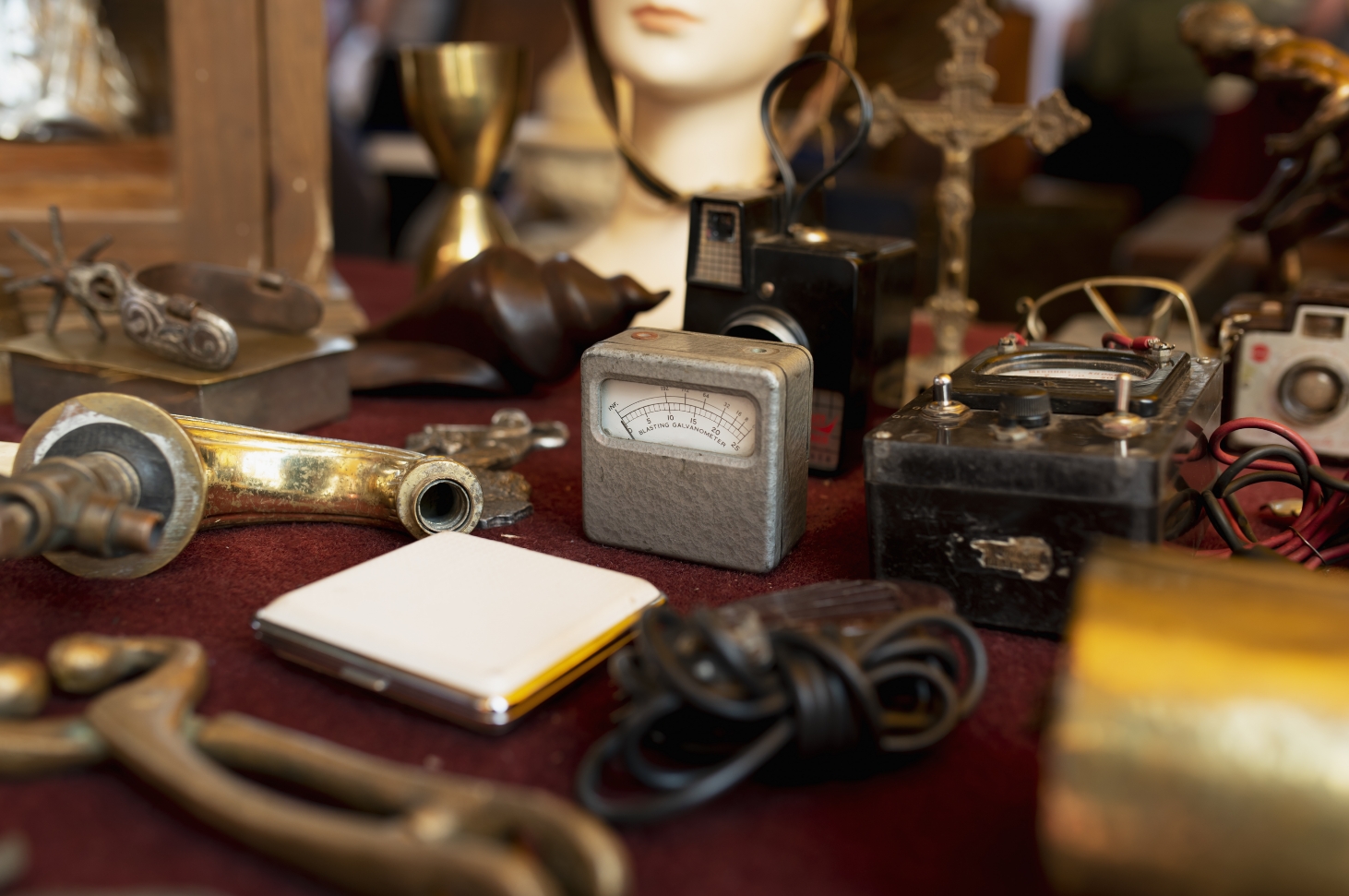 Vintage collectibles and tools displayed on a pawnshop counter showcasing the historic roots of the pawn industry