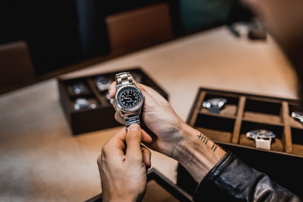Luxury wristwatch being evaluated by a jeweler in a pawnshop