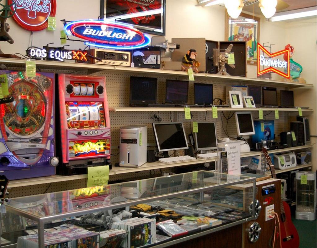 Various power tools displayed on shelves in a pawnshop