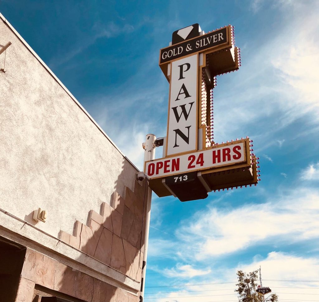 Gold & Silver Pawn Shop signboard under blue sky
