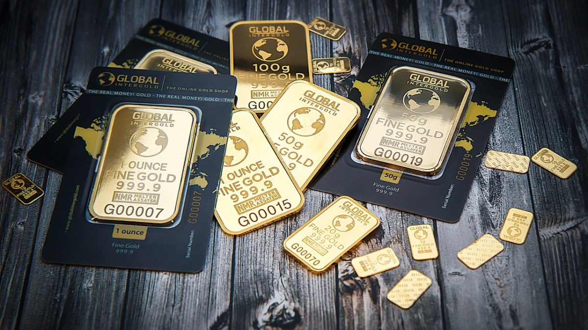 Gold bars displayed on wooden surface