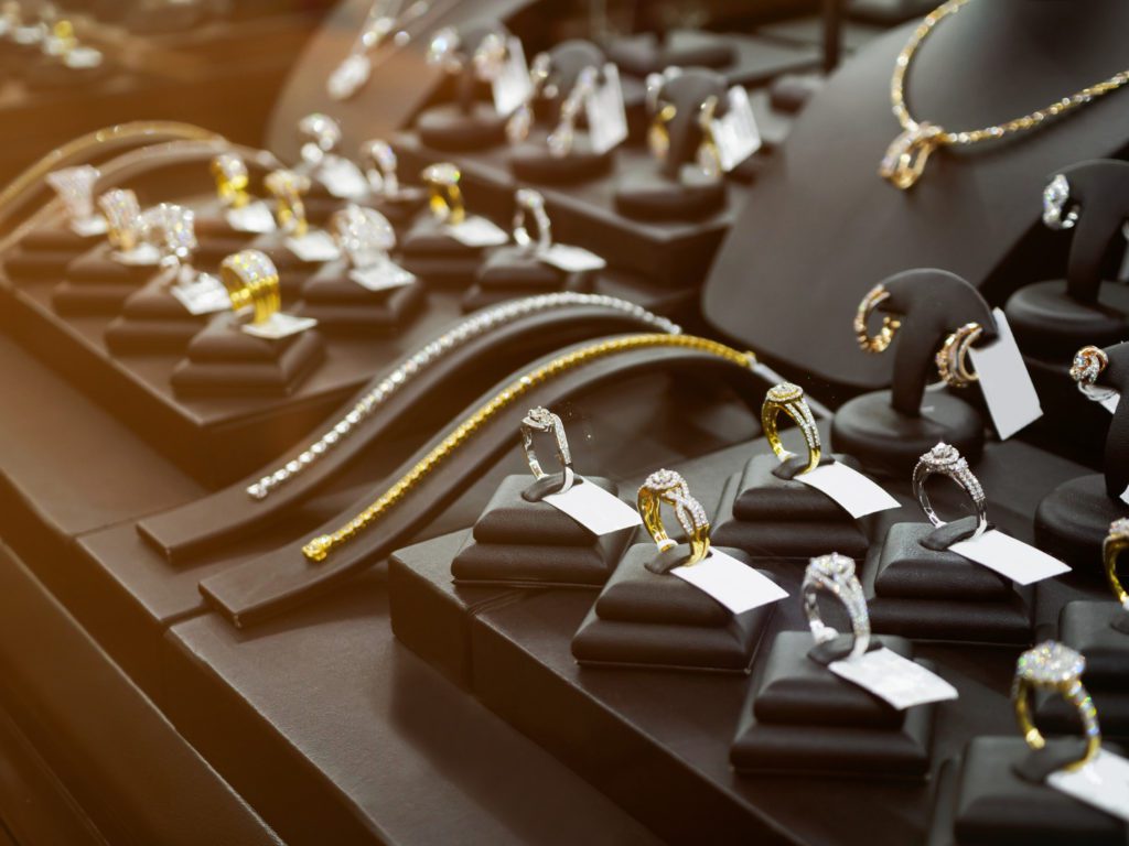 Gold and diamond rings and necklaces in a pawn shop display