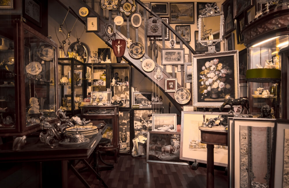 Glass display case with vintage jewelry, collectibles, and rare items in a pawn shop