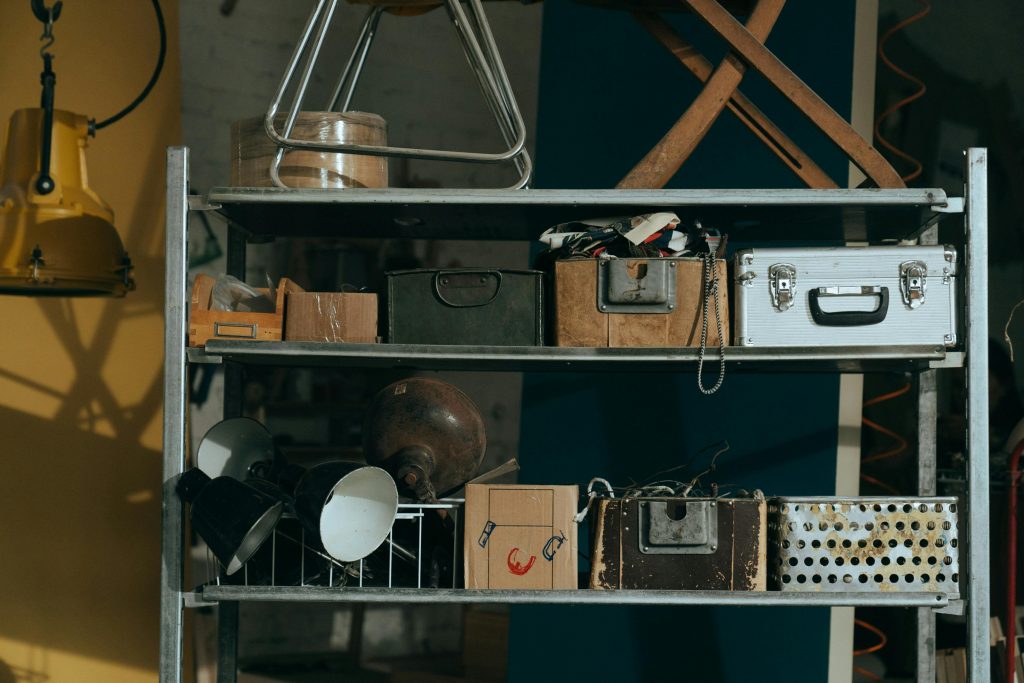 A shelf filled with vintage and miscellaneous items prepared for sale