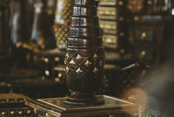 Ornate wooden luxury collectibles and furniture on display in a pawn shop