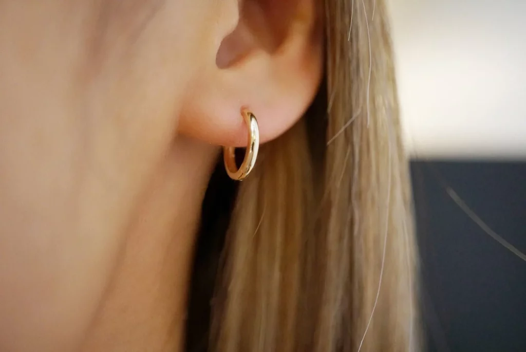 14 karat gold huggie earrings displayed at ideal jewelry and loan pawn shop Brockton